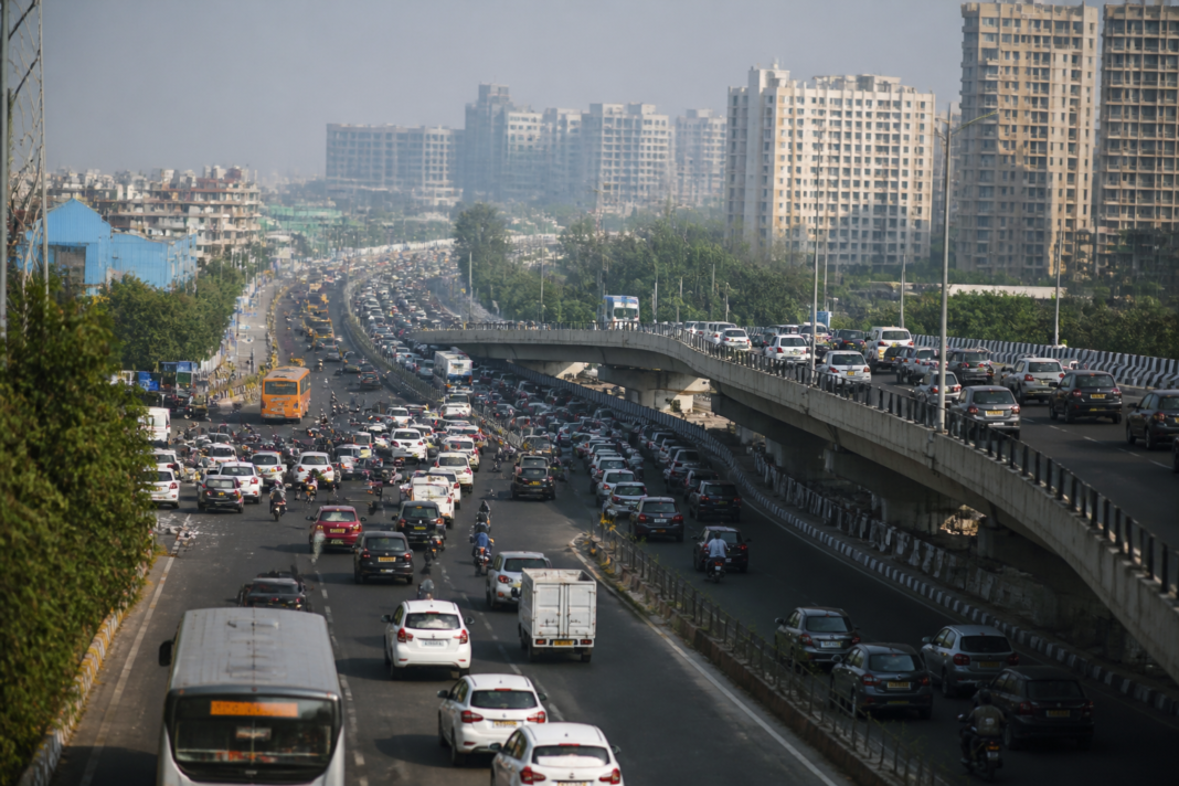 Delhi-Gurugram elevated road corridor with traffic moving along MG Road near the city border
