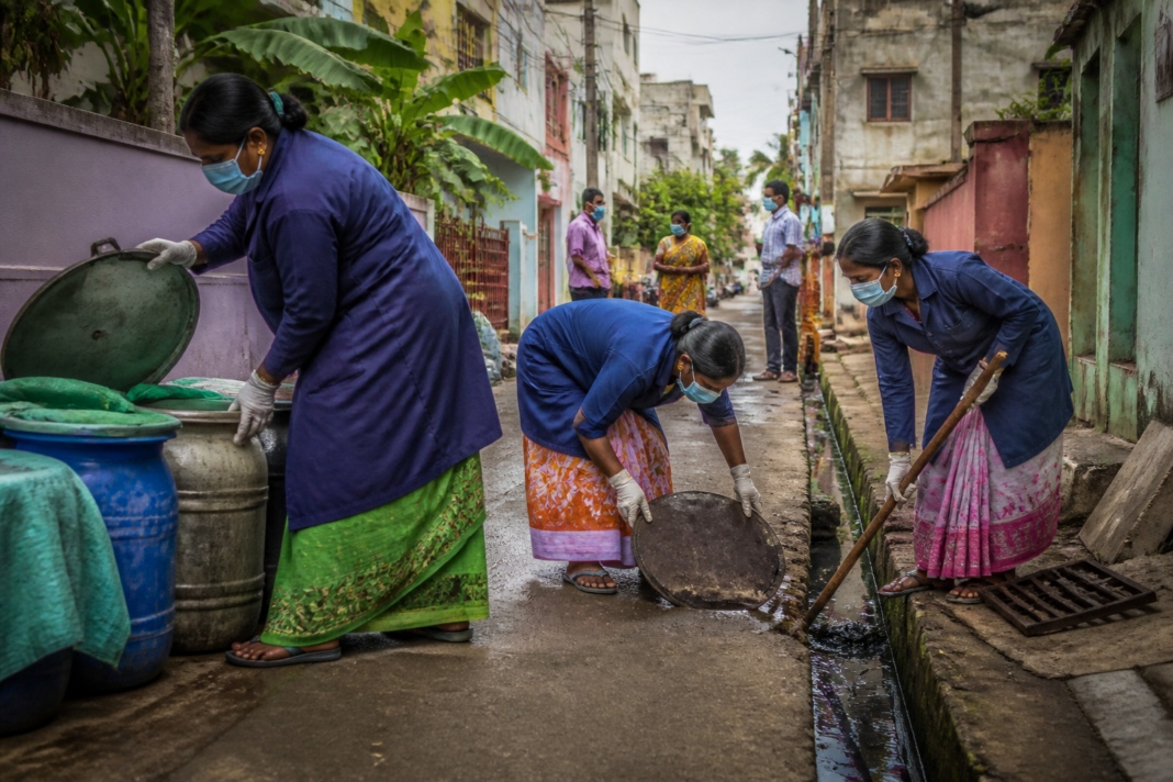 Chennai dengue cases and municipal workers inspecting mosquito-breeding sites in an urban neighbourhood