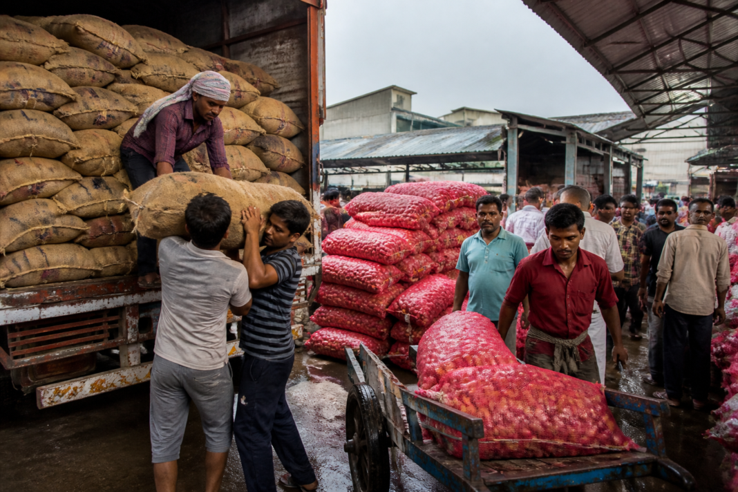 Mathadi workers handling sacks at the Navi Mumbai APMC onion market