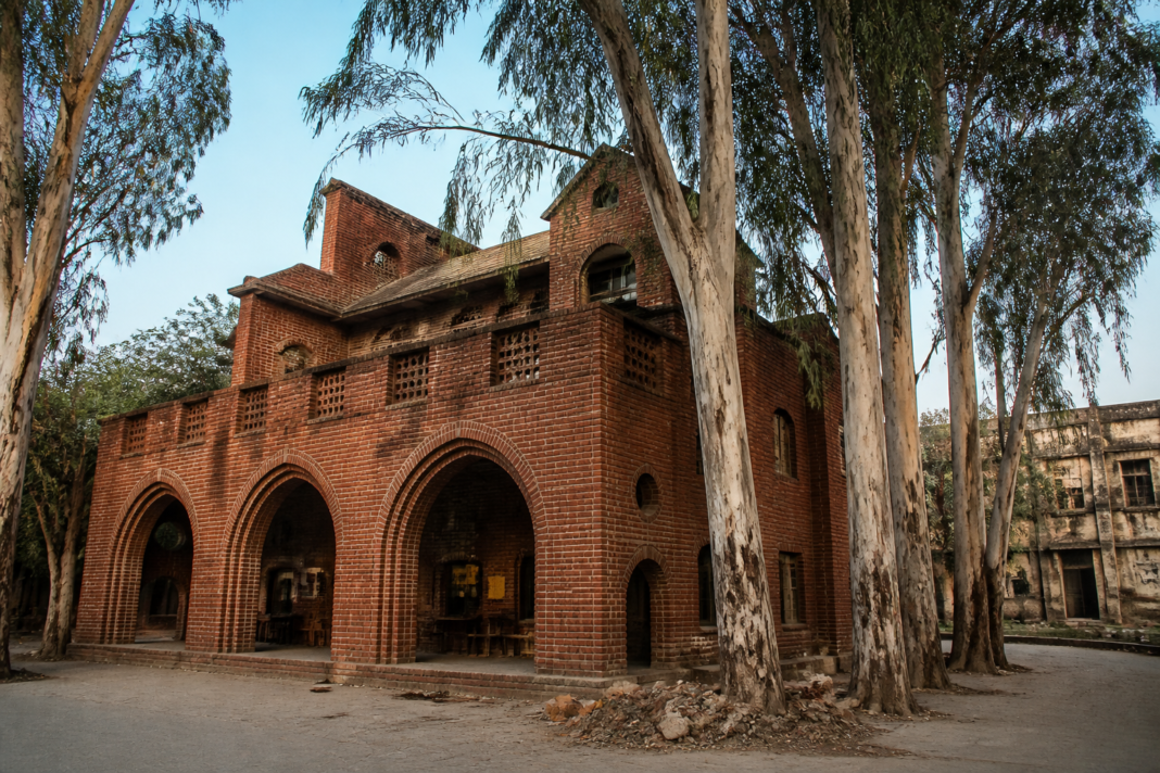 Red House Okhla showing exposed brick walls, Gothic arches and terracotta roofs in Delhi