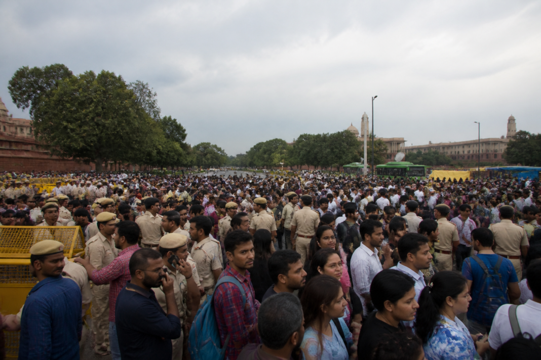 Delhi protest near Jantar Mantar with police barricades and commuters facing metro closures