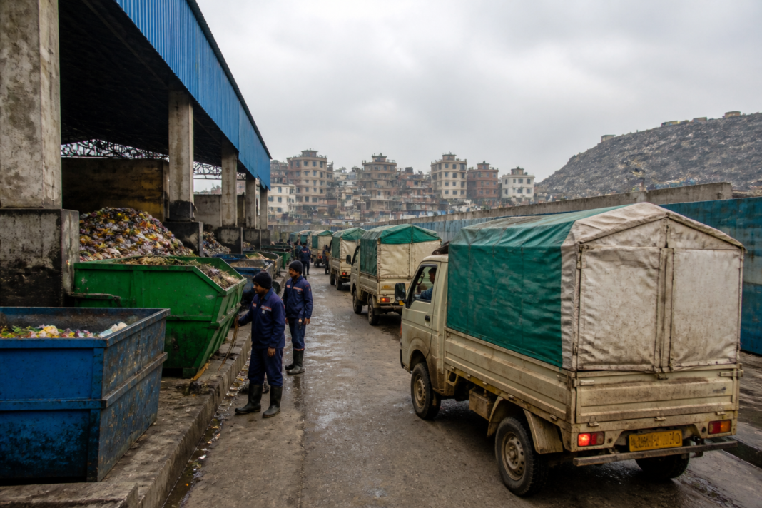 Delhi waste management workers collect segregated waste near an MCD transfer station