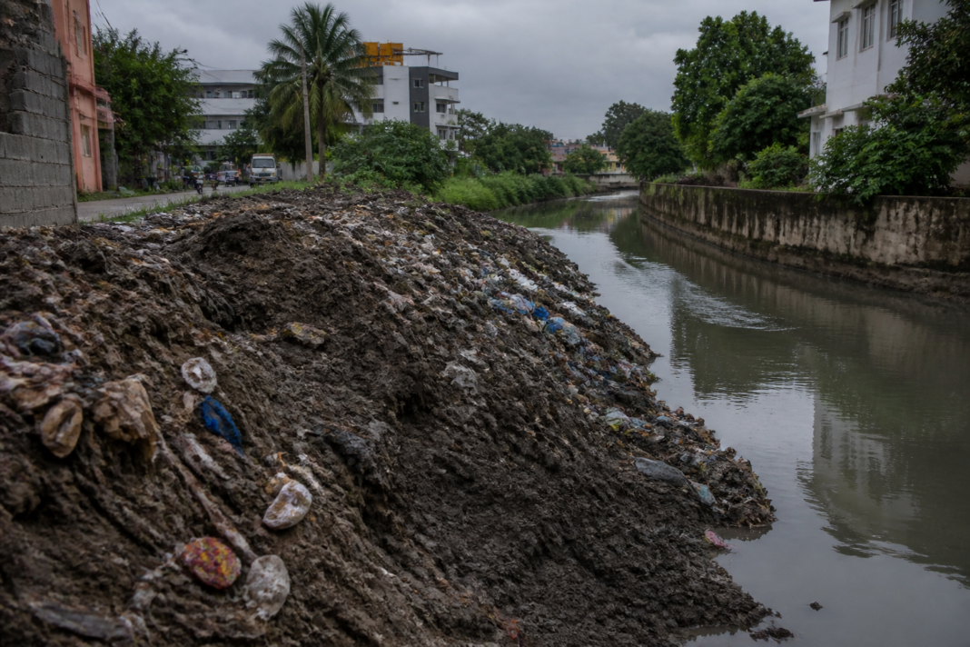 Coimbatore canal pollution near Veerakeralam with silt and waste along the waterway
