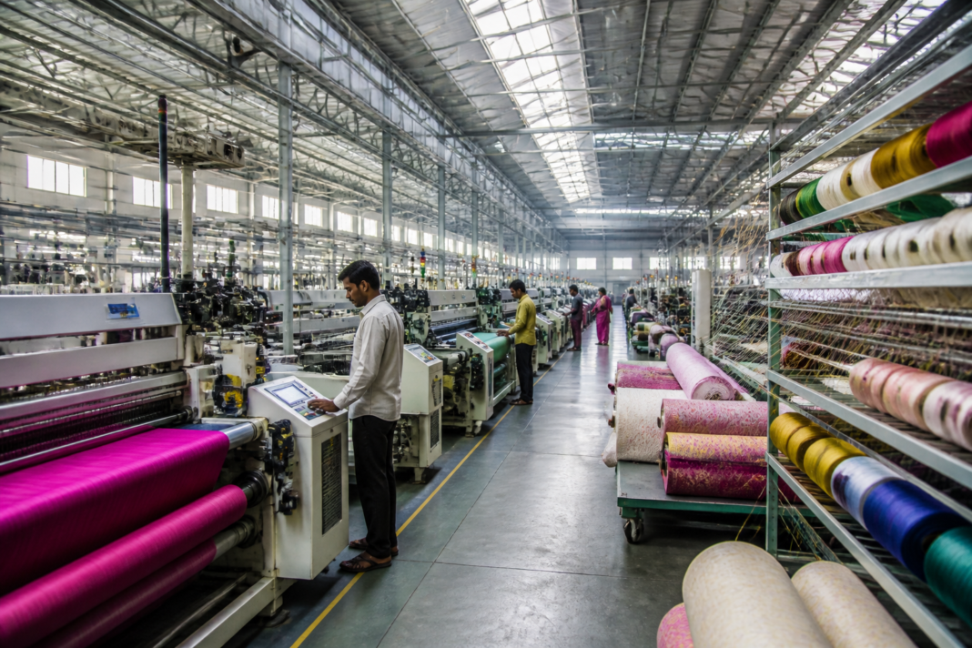 Surat textile industry workers and machinery inside a textile manufacturing unit