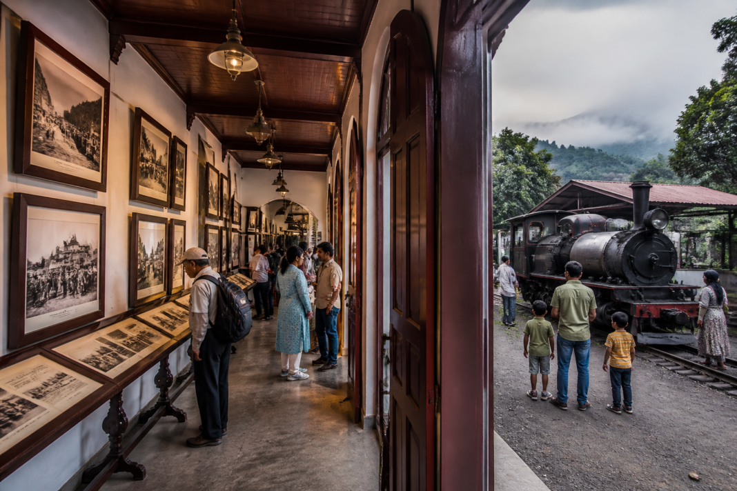 DHR heritage gallery at Sukna displaying historic photographs of the Darjeeling Himalayan Railway.