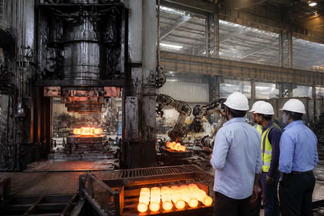 Chennai forging industry workers operating precision metalworking equipment in an industrial facility