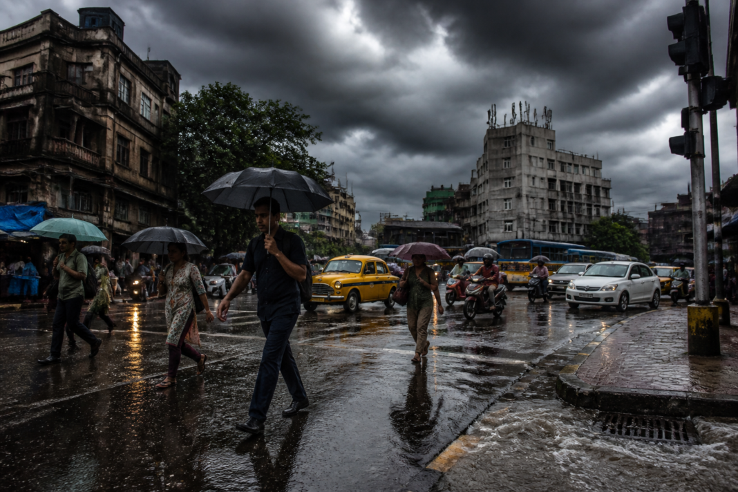 West Bengal rain forecast showing a stormy Kolkata street with rain and dark monsoon clouds