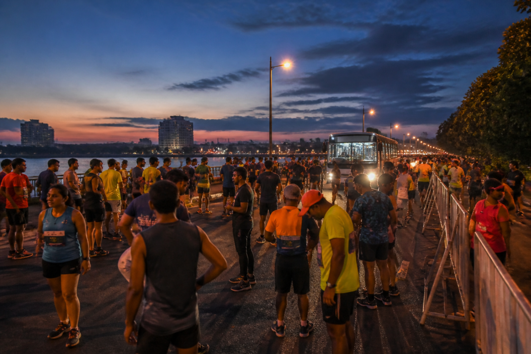 Kochi Spice Coast Marathon runners gathering near Marine Drive with Kochi Metro access