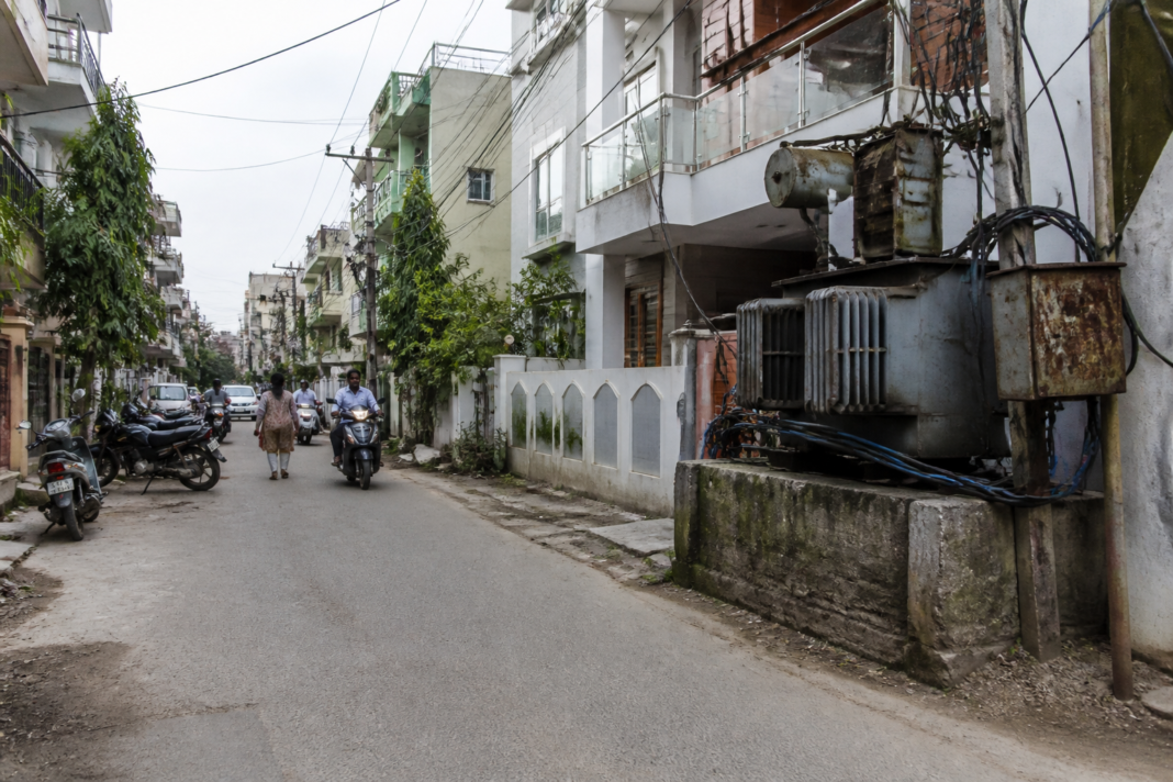 Lucknow urban planning with roadside power transformers and a residential colony street