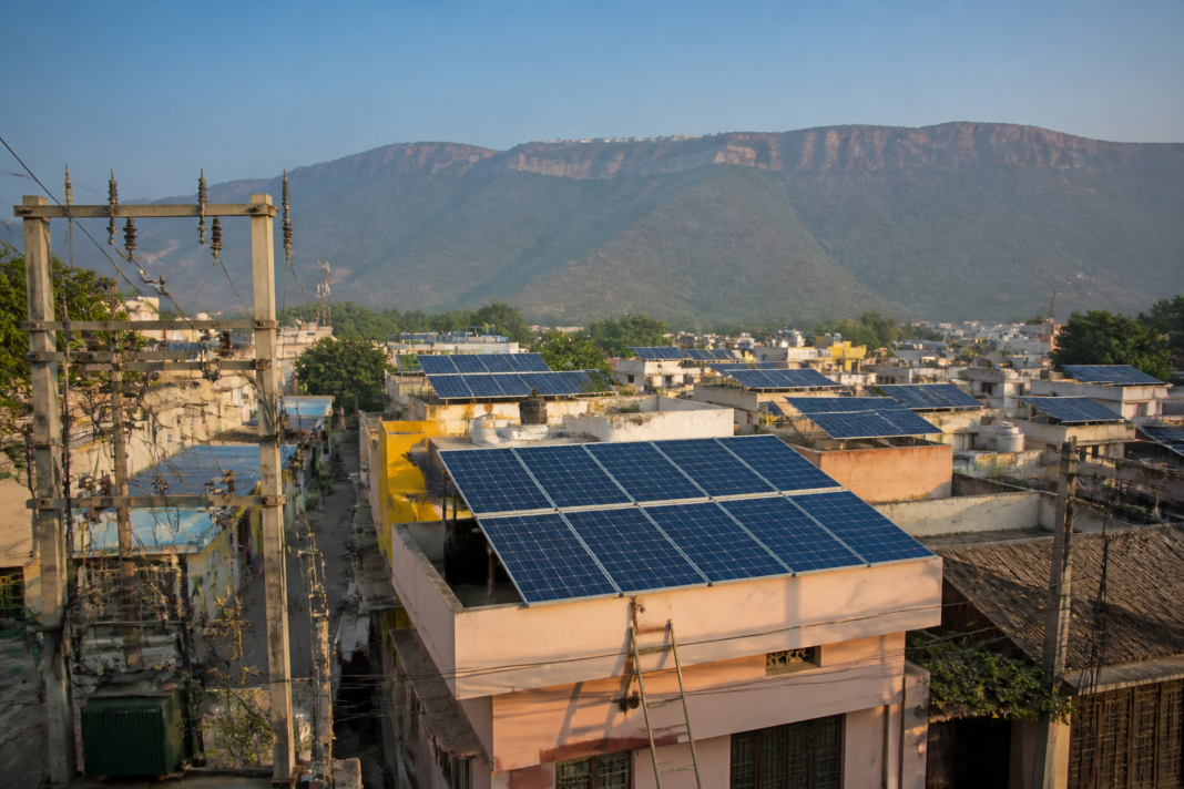Andhra Pradesh clean energy expansion with rooftop solar panels and power distribution infrastructure.