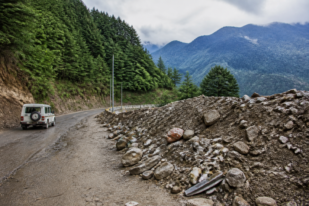 Dharamshala muck dumping near forested slopes and mountain roads in Kangra district