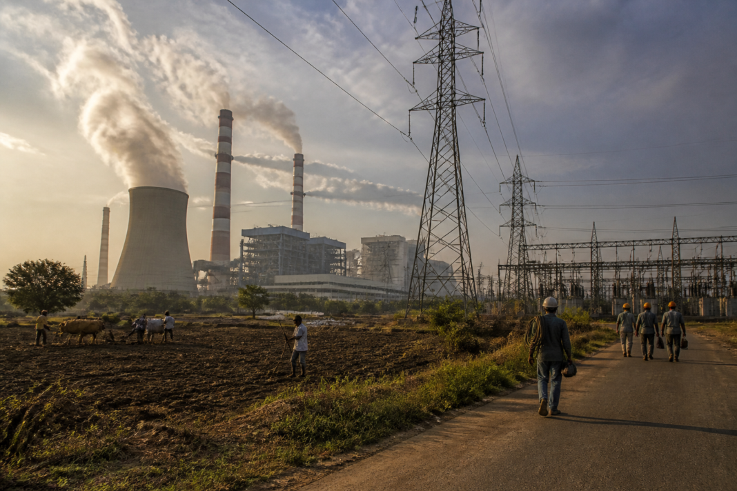 Telangana power crisis represented by a thermal power plant and electricity transmission lines near Hyderabad
