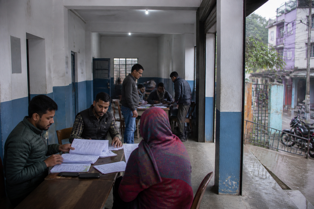 Ranchi SIR camps at a polling station with officials assisting voters during electoral-roll verification.