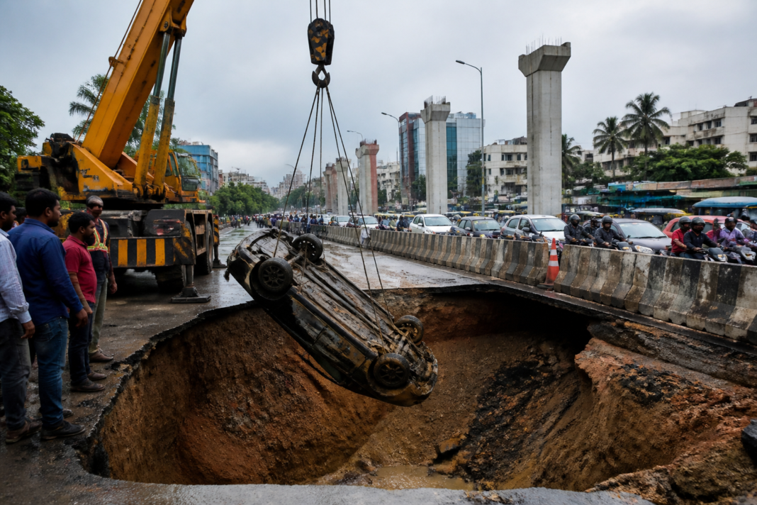 Chennai road cave-in near Thiruvanmiyur with a car being recovered by crane