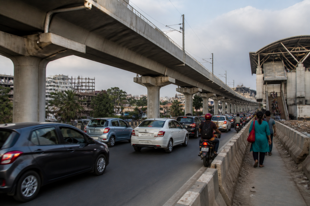 Pune Metro pillars narrowing a busy road near a station and affecting traffic flow