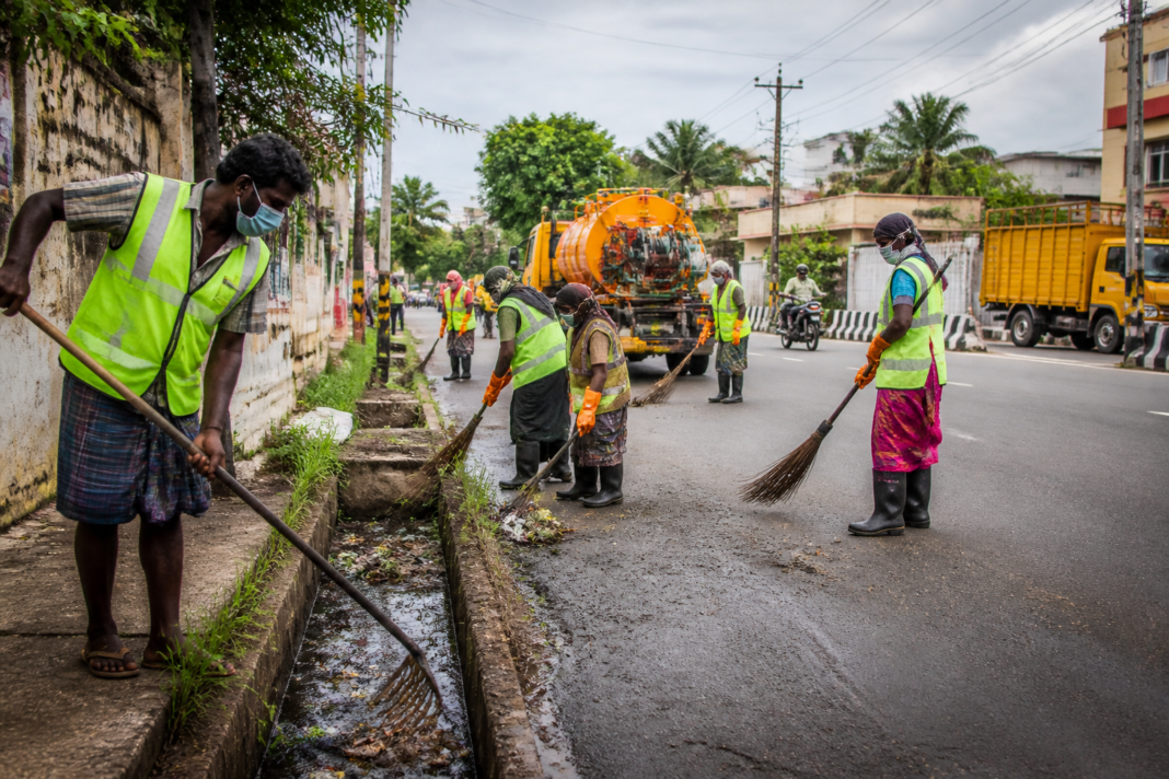 Karur cleaning tenders and municipal sanitation workers cleaning an urban street