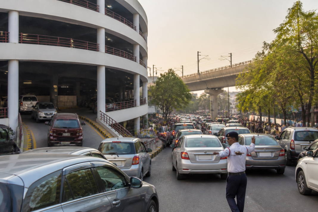 Delhi parking facilities and vehicles on a congested urban road