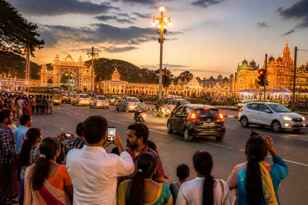 Mysuru Dasara lights attracting visitors near the illuminated palace roads in Mysuru