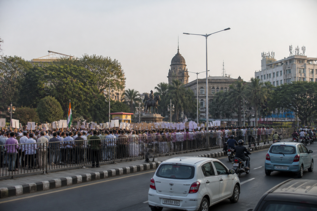 Pune protest sites proposal discussed against a backdrop of a busy urban road and civic buildings
