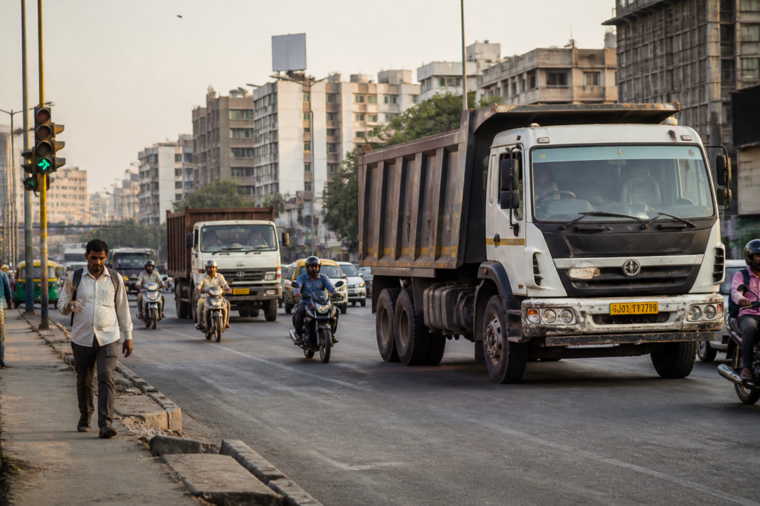 Ahmedabad dumpers and trucks moving through city traffic under road safety scrutiny