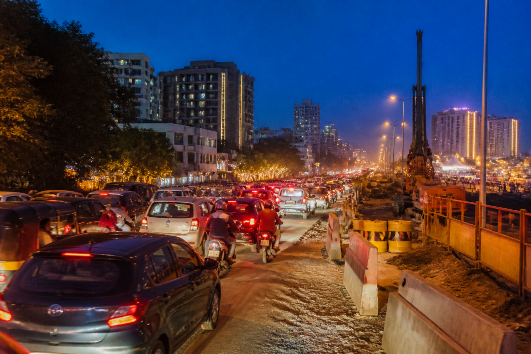 Ahmedabad Navratri traffic building up near SG Highway amid roadworks and barricades.