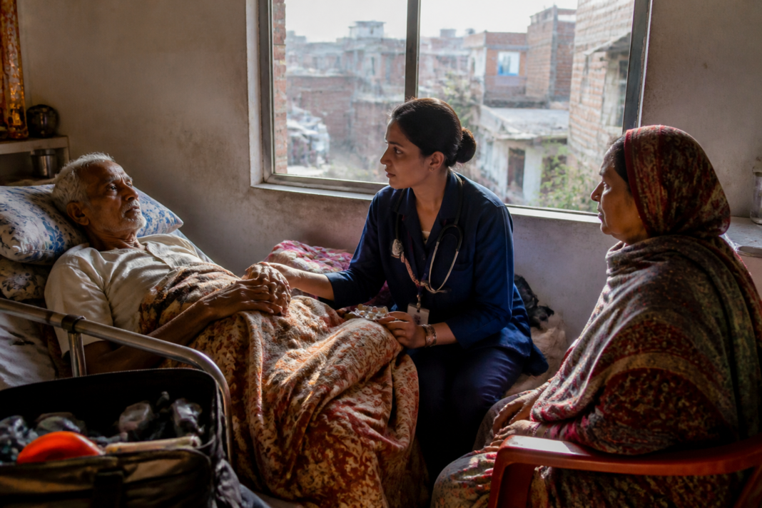 Palliative care nurse visiting an elderly patient at home in India