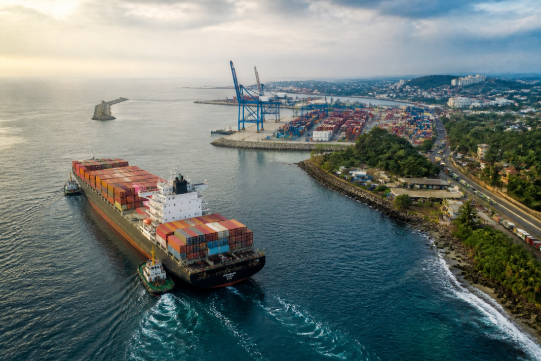 Kerala port city plan with cargo vessels and coastal logistics infrastructure near Vizhinjam