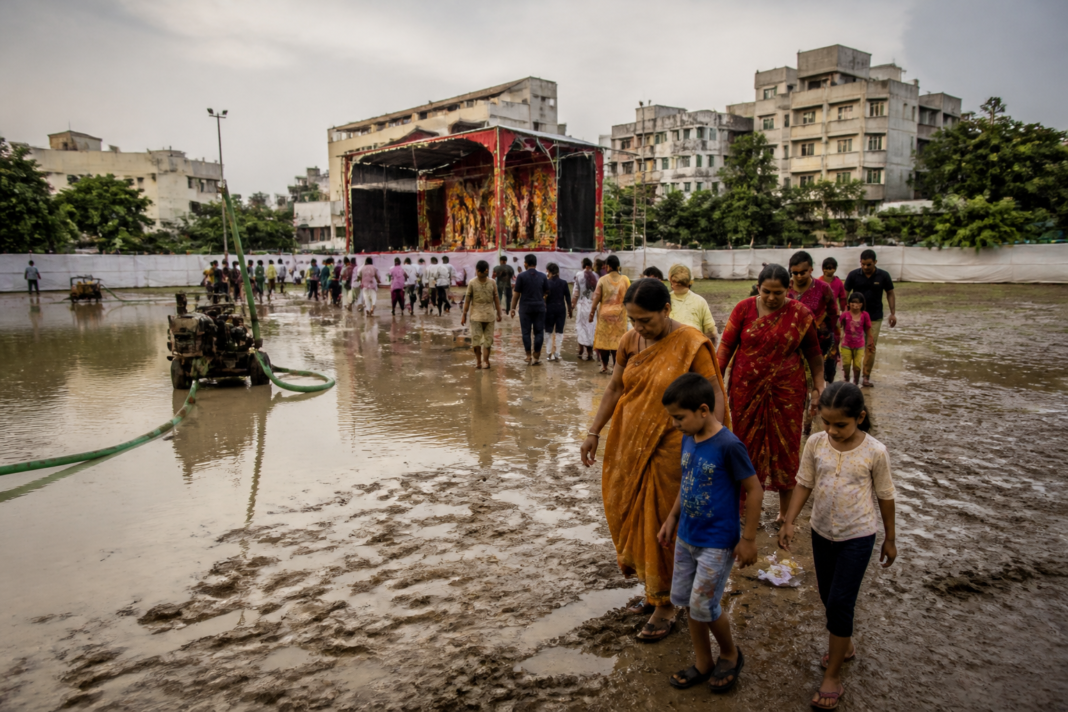 Ghaziabad Ramlila grounds waterlogged after rain, with muddy pathways and temporary pumps.