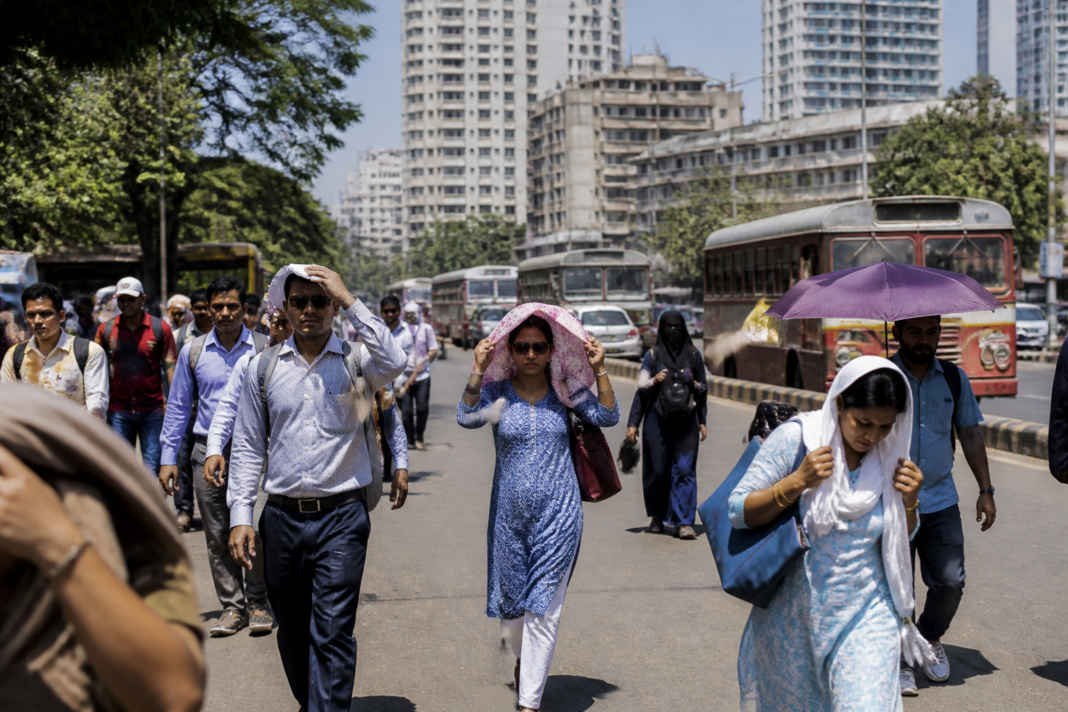 Mumbai heatwave warning as residents walk along a sunlit city road in hot weather