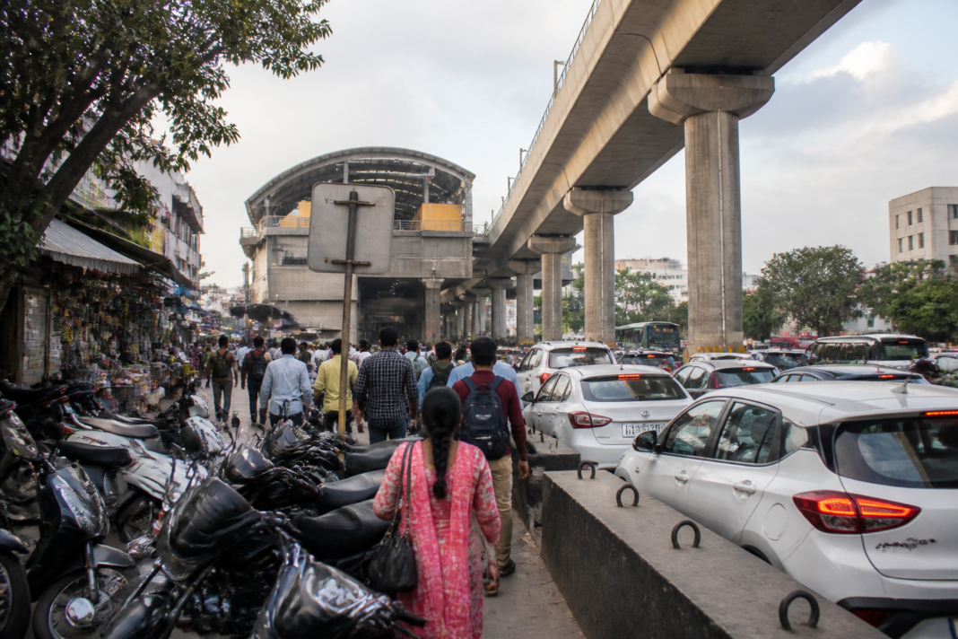 Pune Metro pedestrian access blocked by parked two-wheelers near a station footpath