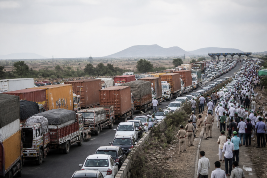 NH48 traffic disruption with trucks stranded near the Kognoli toll plaza during a farmers’ protest