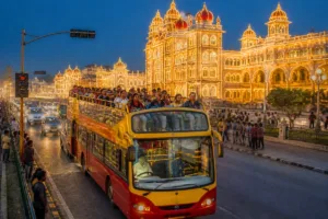 Mysuru Ambari Bus Rides Surge as Dasara Lights Draw 8,000 Tourists Mysuru Ambari bus carrying tourists past illuminated heritage streets during Dasara