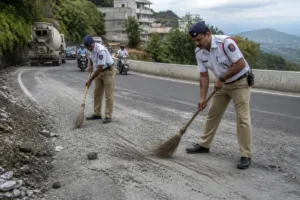 Traffic police clearing road debris at Pirangut Ghat near Pune